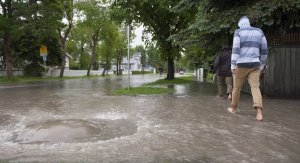 Man Walking in Flooded Neighbourhood