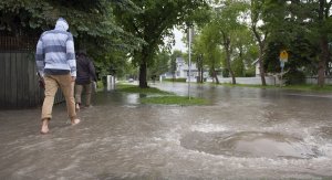 Man Walking in Flooded Neighbourhood