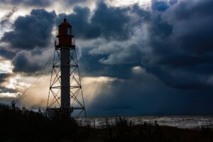 lighthouse and a storm cloud over the sea
