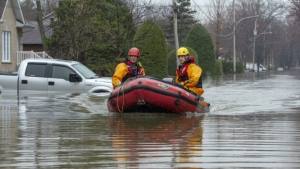 two people in raft floating in flooded street