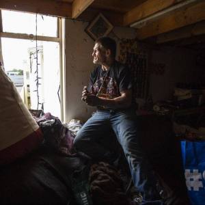Man looking out window