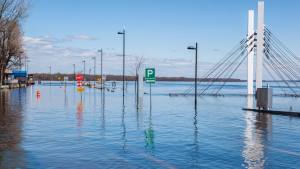 Flooded road with stop signs and street lights