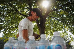 Brent Korkum hands out water to unhoused folks